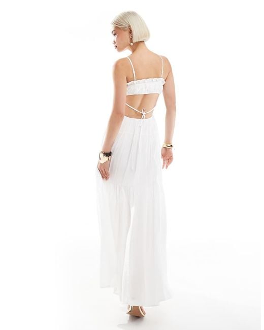 The Frolic White Exclusive Tie Front Ruffle Trim Open Back Tiered Maxi Dress