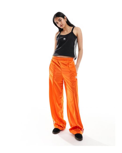 Top senza maniche con tre strisce di Adidas Originals in Orange
