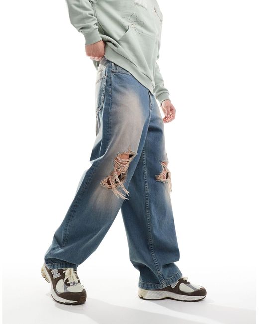 Jeans ampi lavaggio tinto con strappi sulle ginocchia di ASOS in Blue da Uomo