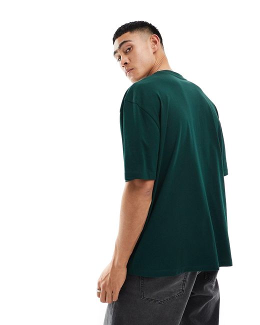 T-shirt oversize scuro con scritta sul petto di ASOS in Green da Uomo