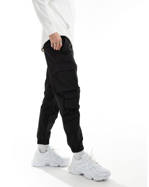 Pantalon cargo technique à poches Bershka pour homme en coloris Black