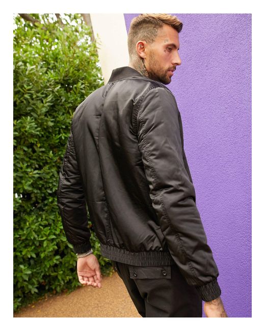 Chaqueta bomber acolchada en con forro naranja y bolsillo ma1 ASOS de  hombre de color Negro | Lyst