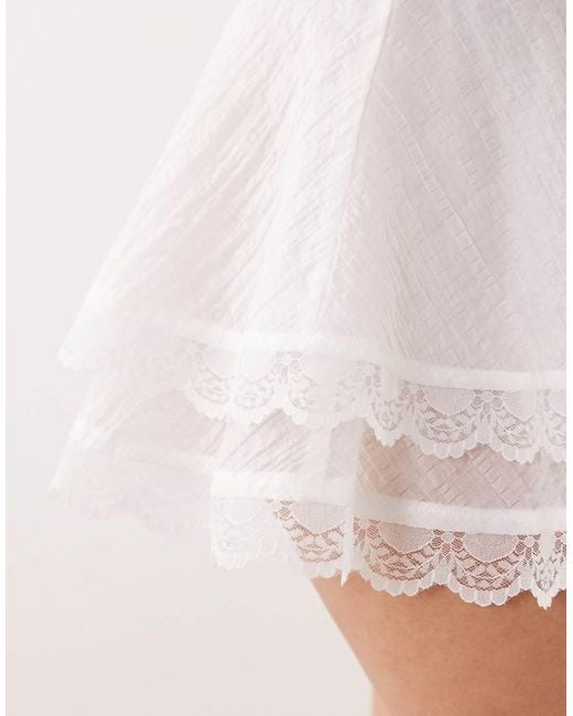 The Frolic White Exclusive Lace Trim Tiered Mini Frilly Skirt