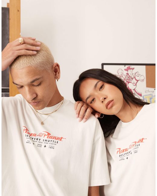 Disney pixar - t-shirt unisexe oversize avec imprimés toy story pizza planet - délavé ASOS en coloris Black