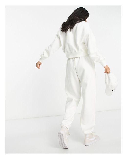 Nike Mini Swoosh Oversized High Rise joggers in White | Lyst