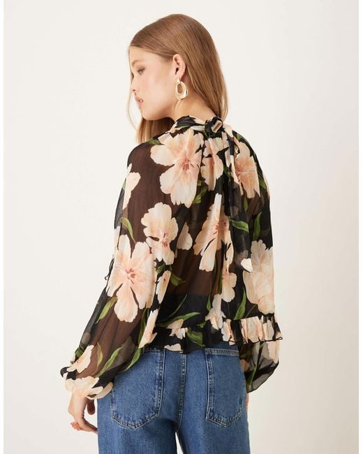 Blouse transparente à col rond et manches longues - base foncée fleurie Mango en coloris Blue