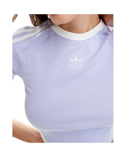 T-shirt ristretta lilla pastello con tre strisce di Adidas Originals in Blue