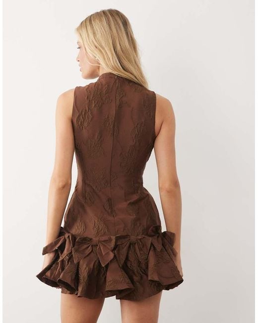 Sister Jane Natural Exclusive Jacquard Sleeveless Cinched Waist Bow Hem Mini Dress