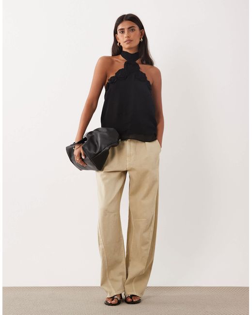 Top dos nu à rosette Mango en coloris Black