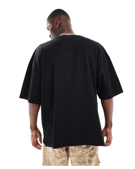 T-shirt super oversize nera con stampa "monaco" sul petto di ASOS in Black da Uomo