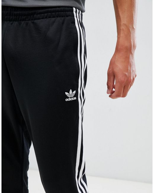 adidas originals superstar 3 stripe joggers in black