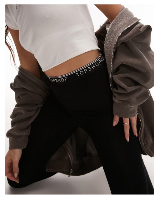 Leggings neri con elastico con logo di TOPSHOP in Black