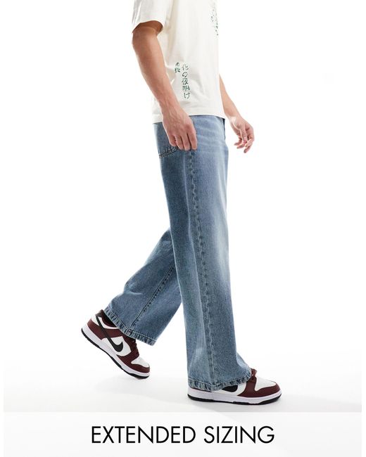 Jeans larghi con fondo ampio lavaggio medio di ASOS in Blue da Uomo