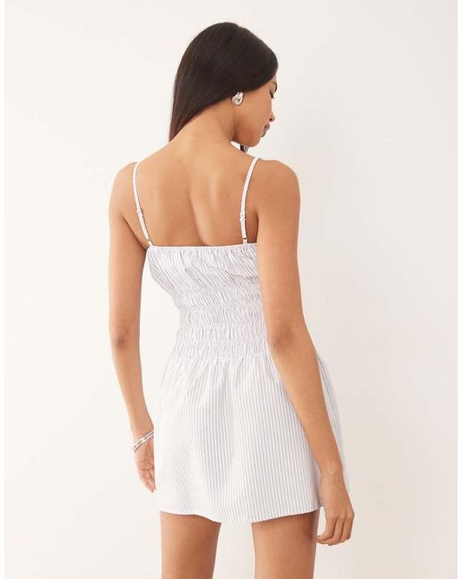 The Frolic White Exclusive Poplin Look Shirred Tie Front Cami Flippy Hem Mini Dress