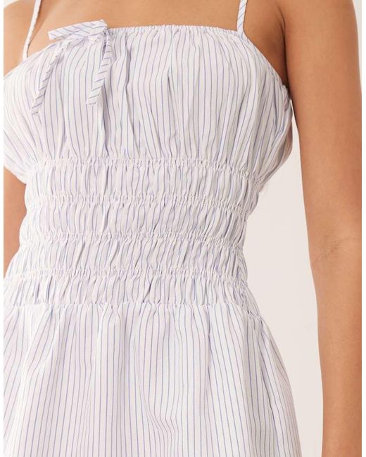 The Frolic White Exclusive Poplin Look Shirred Tie Front Cami Flippy Hem Mini Dress