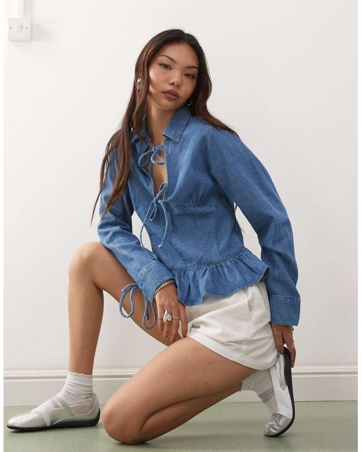 Reclaimed Vintage Blue Long Sleeve Denim Tie Front Top With Peplum Hem