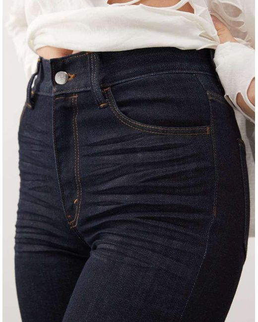 Vaqueros Azul Añil Muy Elásticos De Corte Pitillo Y Talle Alto Con Lavado Enjuagado Sleezie De Cheap Monday de color White