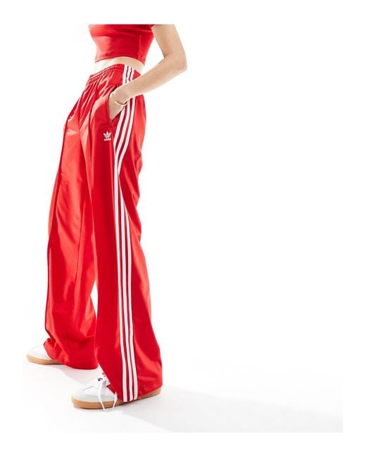 Firebird - pantaloni sportivi rossi di Adidas Originals in Red