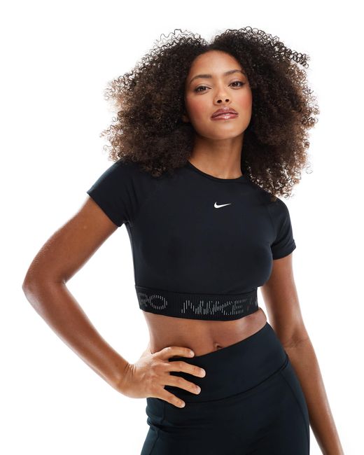 Nike - pro - t-shirt crop top Nike en coloris Black