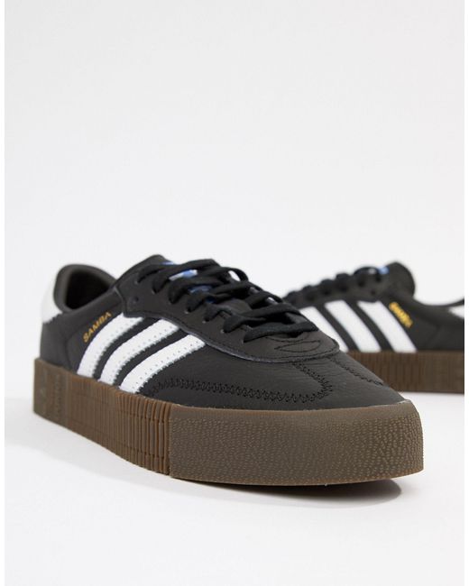 black trainers with gum sole