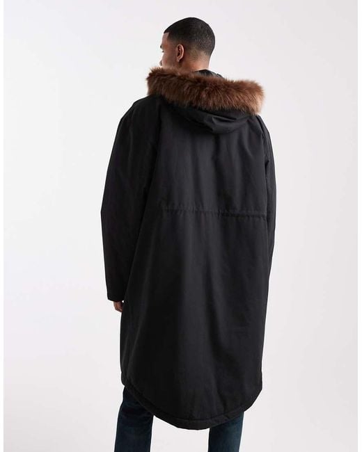 Chaqueta De Plumas Negra Extragrande Con Capucha De Piel Sintética De ASOS de hombre de color Black