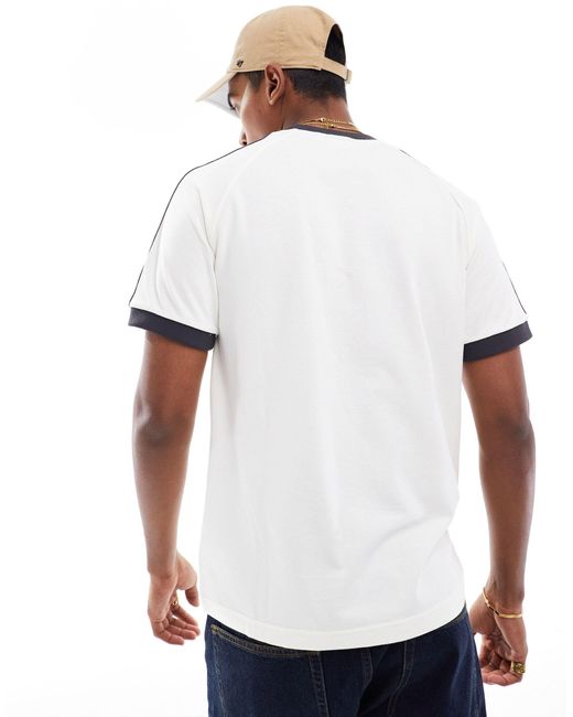 Adidas originals - adicolor - t-shirt allemagne à 3 bandes Adidas Originals en coloris White