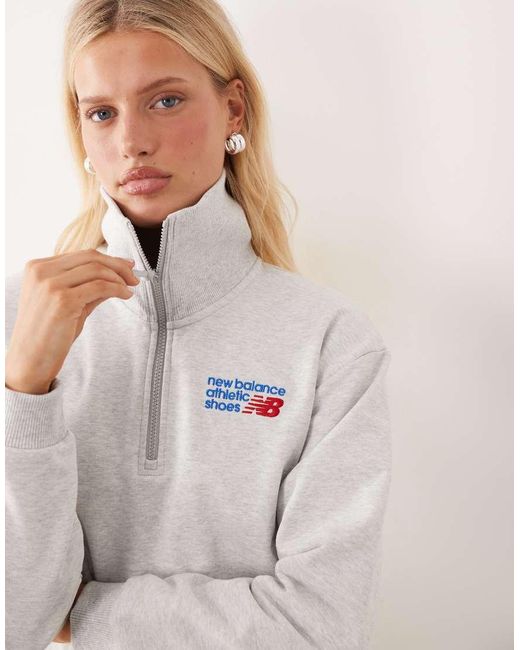 New Balance Natural Athletics Premium Logo Relaxed Fit Cropped Quarter Zip Top