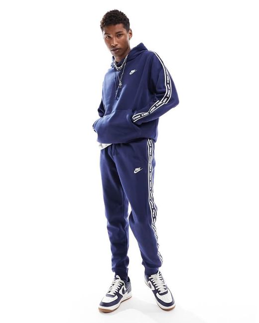 Nike swoosh tape tracksuit hot sale