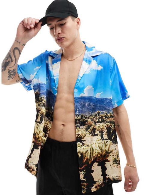 Camisa Holgada Con Estampado De Paisaje Desértico Y Cuello De Solapas Marcadas De Satén De ASOS de hombre de color Blue