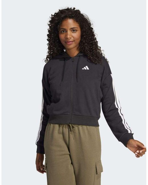 Sudadera Negra Y Blanca Con Capucha, Cremallera Y 3 Rayas De Felpa Rizada Essentials De -Negro Adidas Originals de color Black