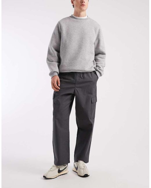 Pantalones Negros Cargo De Corte Tapered Holgado Sin Cierres De Tejido Antidesgarros De ASOS de hombre de color Gray