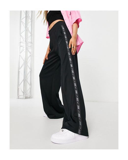 Nike Swoosh Tape Wide Leg joggers in Black | Lyst UK