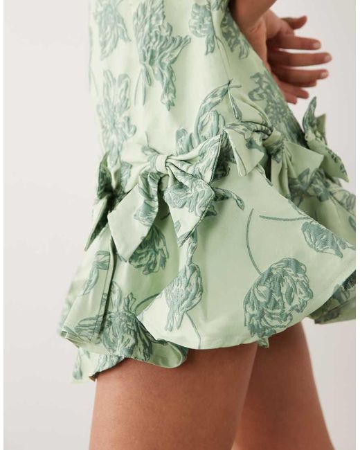 Sister Jane Green Exclusive Jacquard Sleeveless Cinched Waist Bow Hem Mini Dress