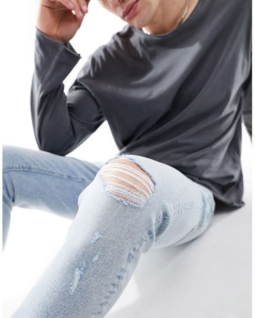 Jean skinny teinté avec déchirures - clair délavé ASOS pour homme en coloris White