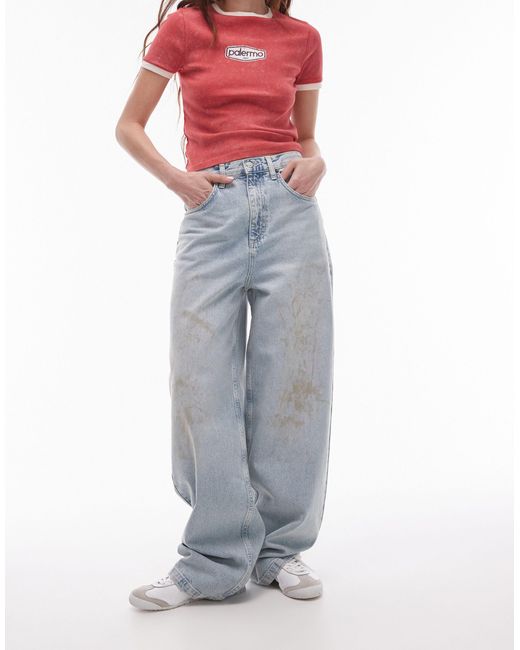 Jeans ampi a vita alta candeggiati con macchie effetto fango di TOPSHOP in Blue