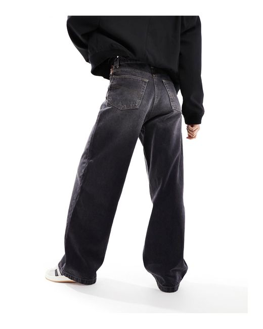 X015 - jeans ampi a vita bassa nero slavato di Collusion in Black