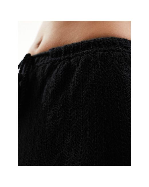 Pantaloni da mare lunghezza integrale neri di Iisla & Bird in Black
