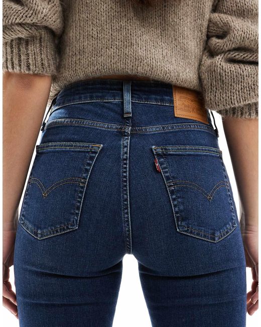 721 - jean skinny à taille haute - délavage moyen Levi's en coloris Blue