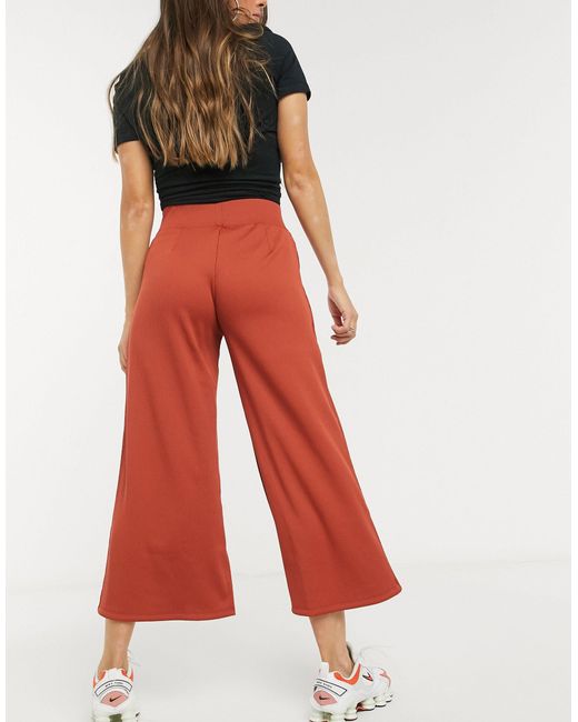 Nike Ribbed High Waist Wide Leg joggers in Orange Lyst UK