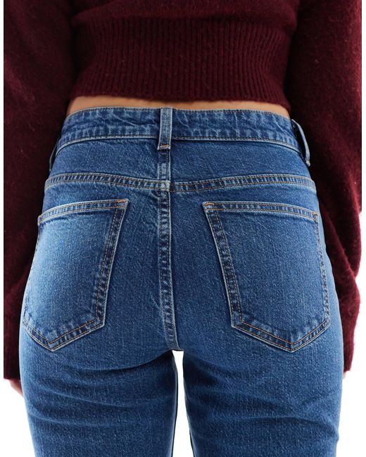 Jean évasé à taille mi-haute - délavage moyen ASOS en coloris Blue