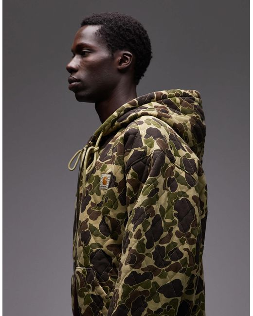 Carhartt – vista – gesteppte oversize-kapuzenjacke mit military-muster in Brown für Herren