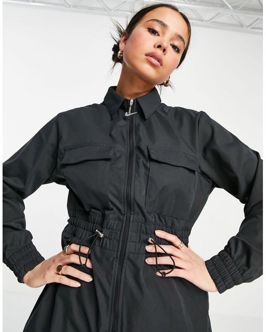 nsw swoosh utility jumpsuit in black