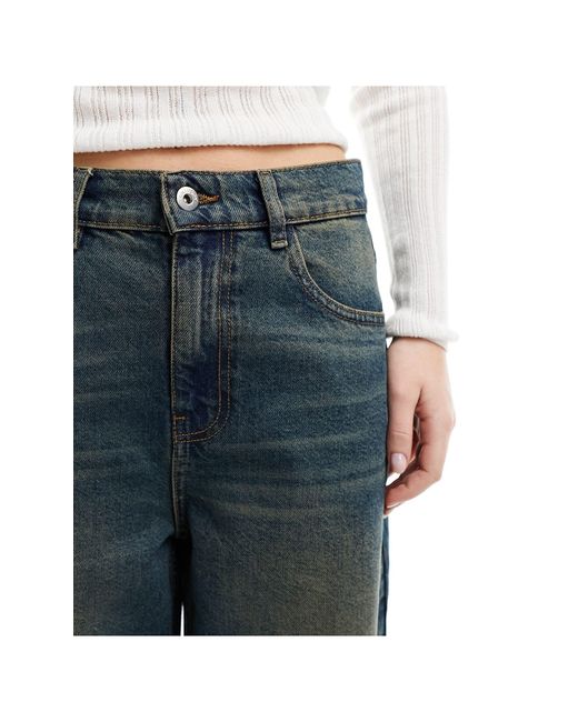 X013 - jeans a fondo ampio a vita medio alta lavaggio sporco di Collusion in Blue