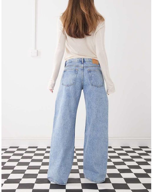 Monki Blue Imoo Low Waist Wide Leg Jeans With Cut Out Bow Details