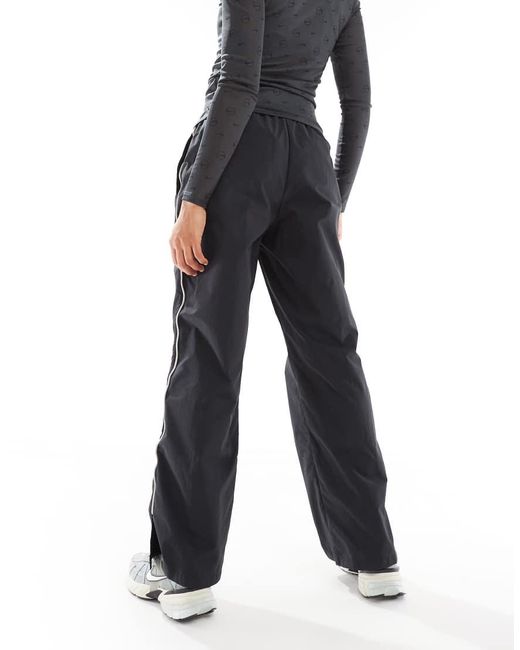 Pantalones Negros Asimétricos Swoosh De Nike de color Blue