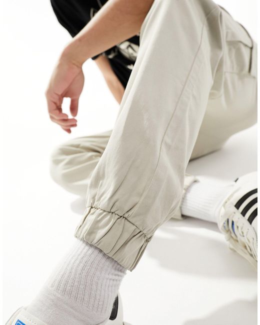 Pantaloni cargo color sabbia con fondo elasticizzato di Bershka in Black da Uomo