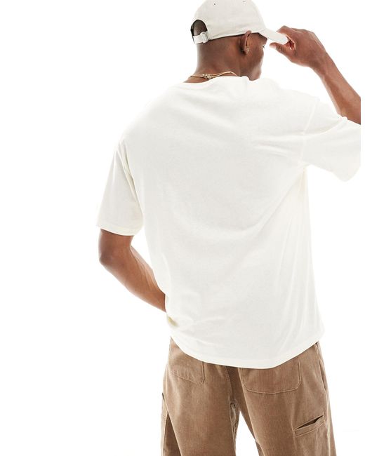 T-shirt oversize sporco con logo sul petto di Jack & Jones in White da Uomo