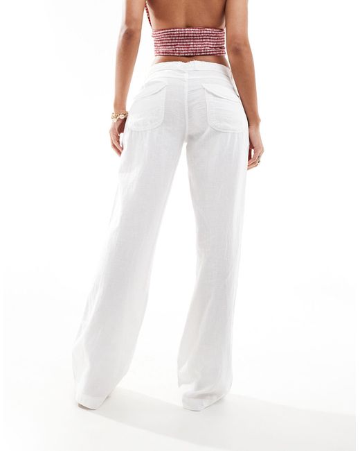 Pantalon taille basse en lin avec poche Bershka en coloris White