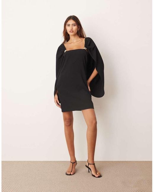 ARRANGE Black Cape Sleeve Mini Shift Dress With Metal Trim Detailing