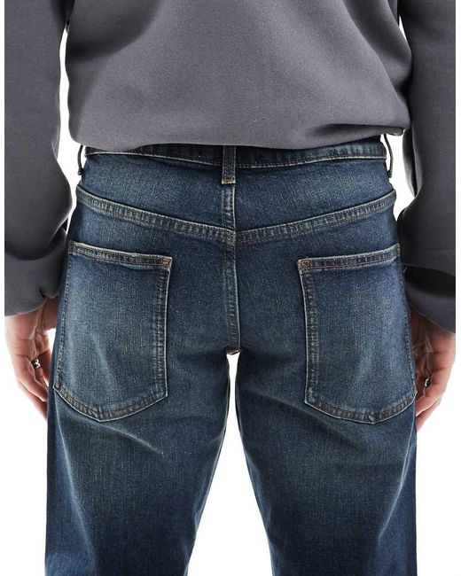 Vaqueros Elásticos De Corte Tapered Con Lavado Azul Medio De ASOS de hombre de color Blue